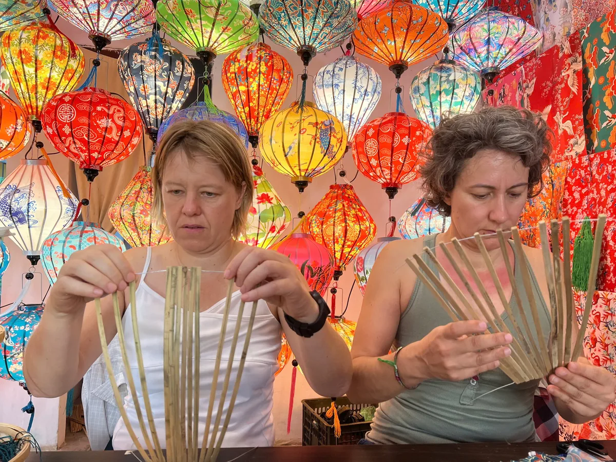 Guests building a traditional bamboo lantern frame