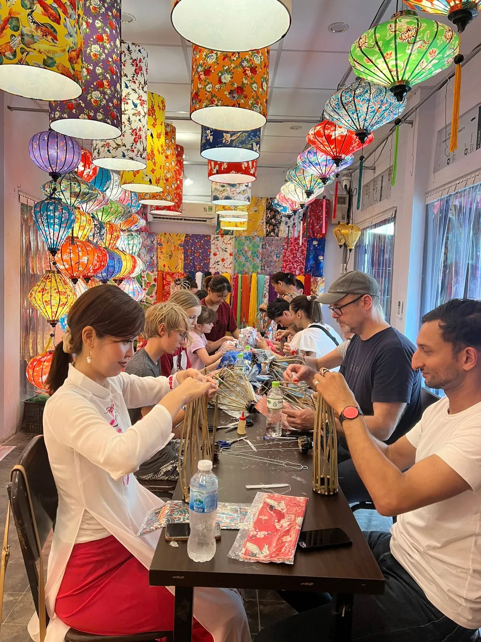 An instructor guiding guests during a lantern making class in Hoi An